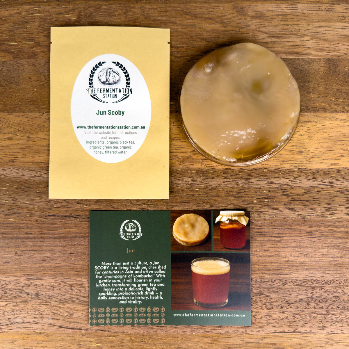 Fermentation starter kit with a SCOBY and packaging on a wooden surface