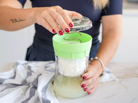 Person using a Kefirko cheese maker.