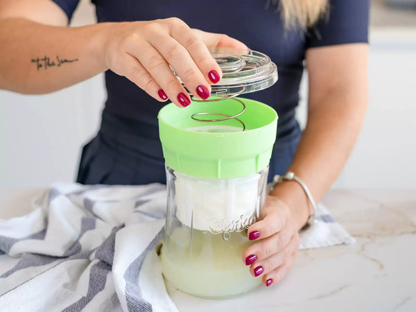 Person using a Kefirko cheese maker.