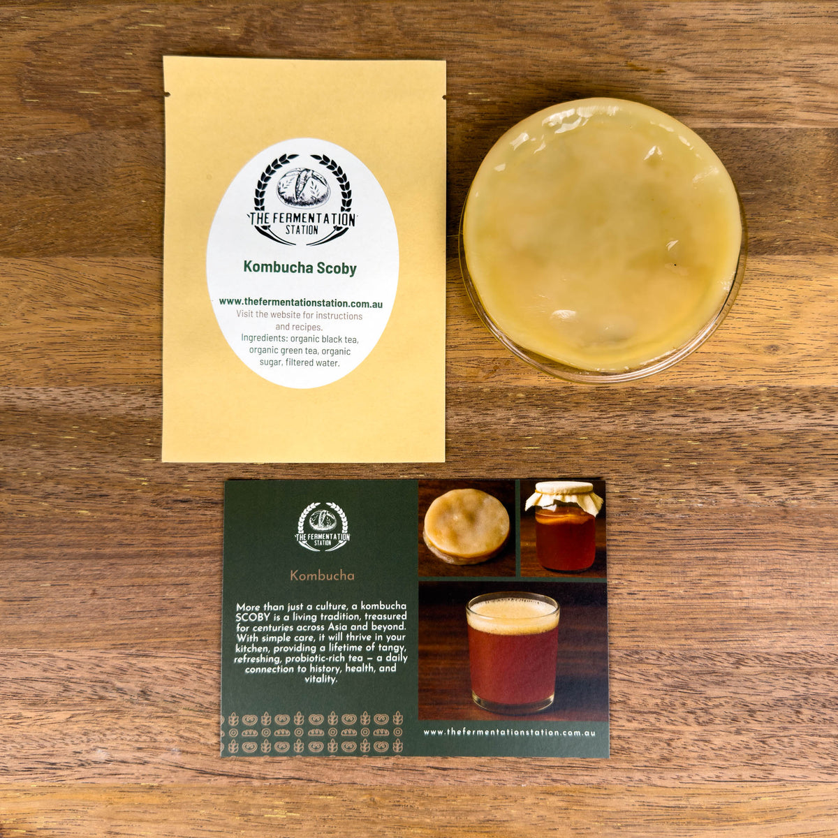 Kombucha scoby with packaging and information card on a wooden surface