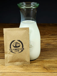 bottle of milk kefir and packet of milk kefir grains