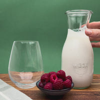 Close-up video of creamy milk kefir being poured into a glass, showing smooth texture and live probiotic richness of fresh organic kefir grains.