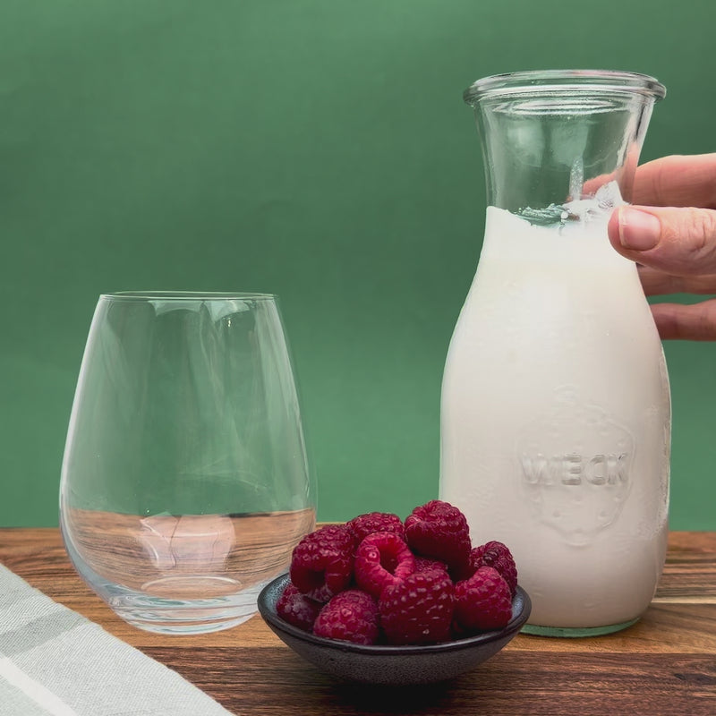 Close-up video of creamy milk kefir being poured into a glass, showing smooth texture and live probiotic richness of fresh organic kefir grains.