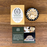 San Franciscan sourdough starter and packaging and promotional material on a wooden surface